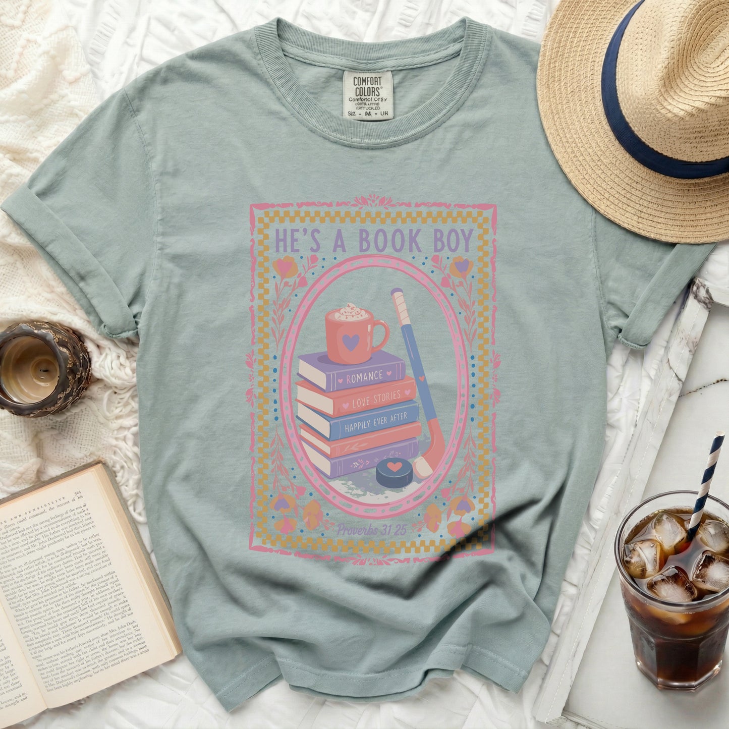 T-shirt with books, hockey stick, puck, and "HE'S A BOOK BOY" text.