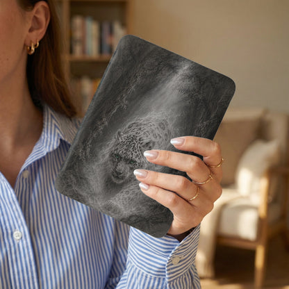 E-reader with a distressed leopard print in a forest scene.