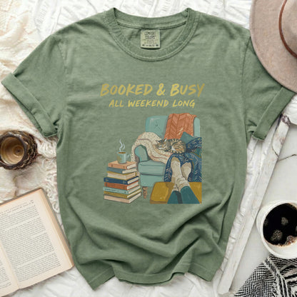 Comfort Colors t-shirt with "Booked & Busy All Weekend Long" text and illustrated cat reading.