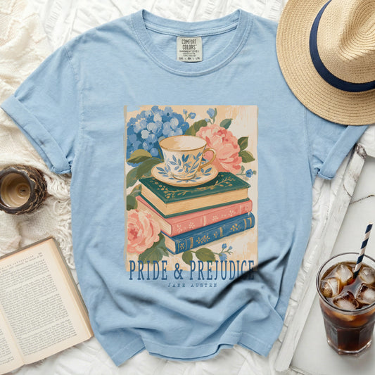 Light blue t-shirt with "Pride & Prejudice" and Jane Austen printed on a floral teacup and book design.