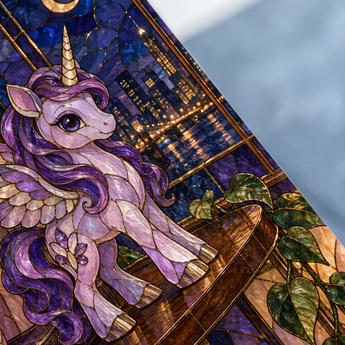 Stained glass unicorn with wings on a wooden surface, against a city skyline at night.