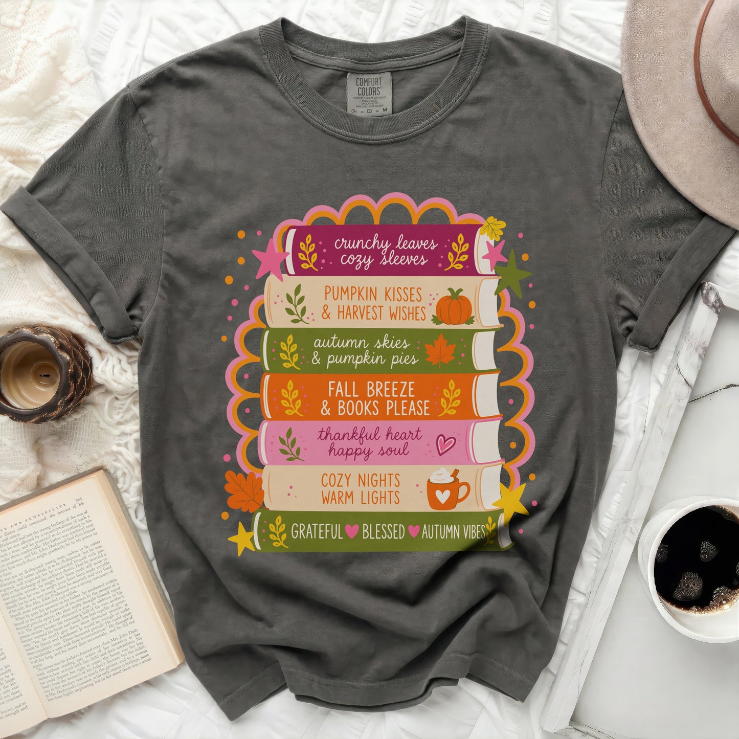 T-shirt with stack of books graphics featuring fall phrases.