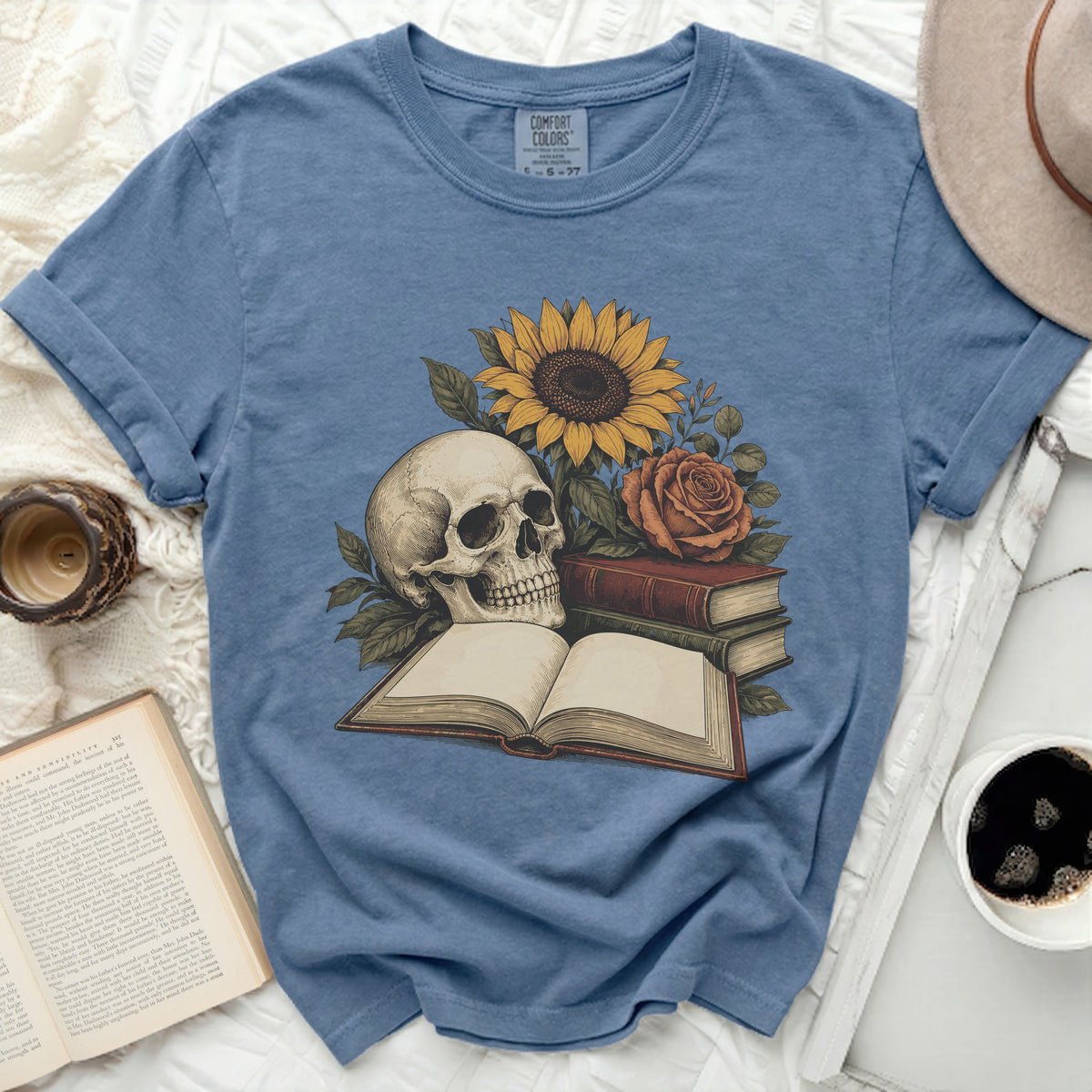 T-shirt with a skull, sunflower, rose, and open books design.