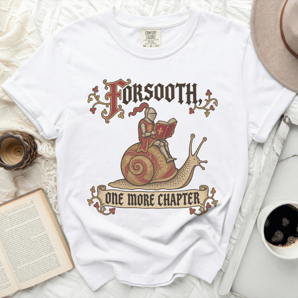 White t-shirt graphic with knight on snail and text "FORSOOTH, ONE MORE CHAPTER".