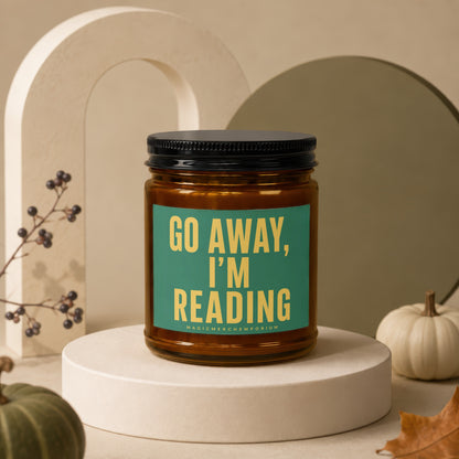 Candle with "Go Away, I'm Reading" text on a teal label.