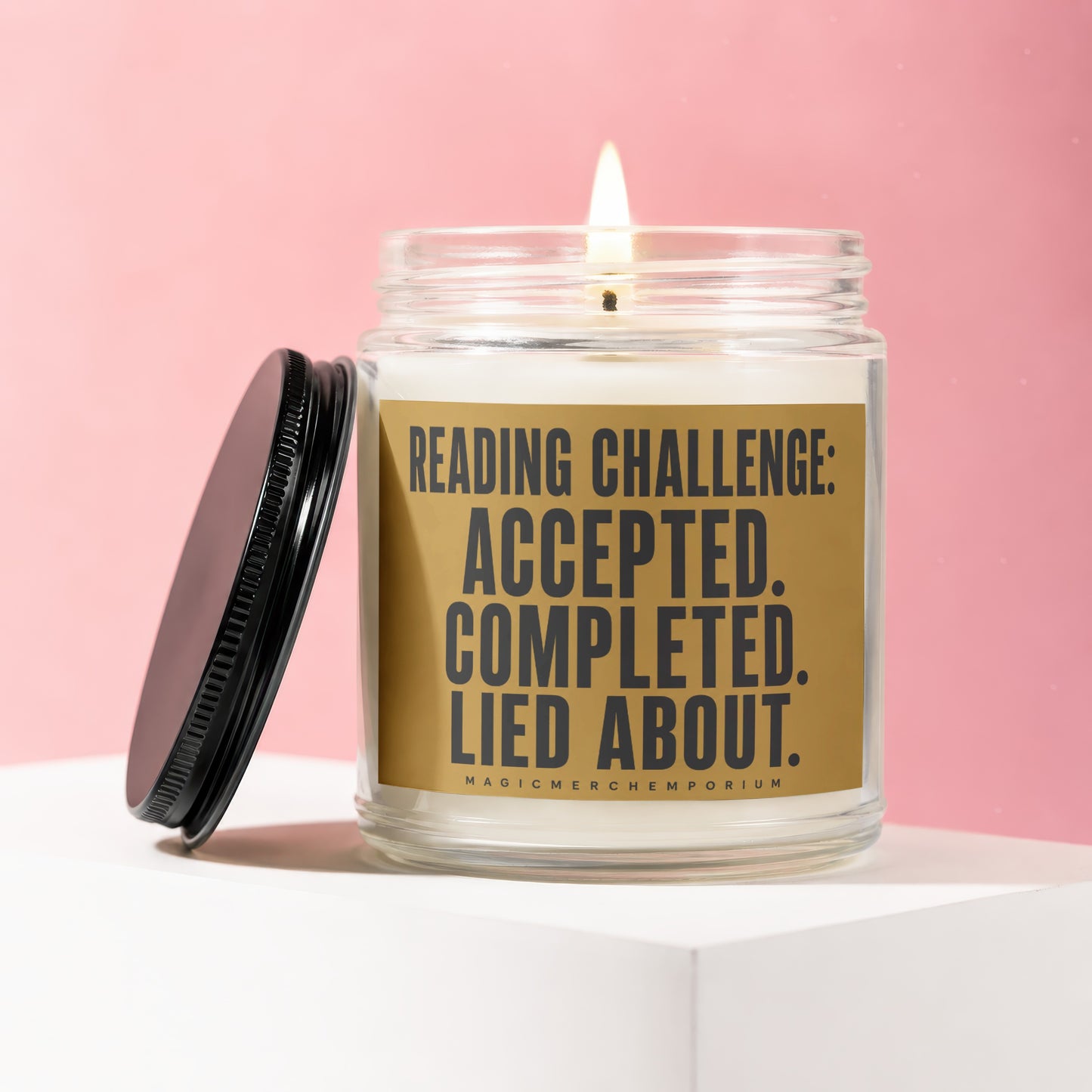 Lit candle in glass jar with lid off, text "Reading Challenge: Accepted. Completed. Lied about."