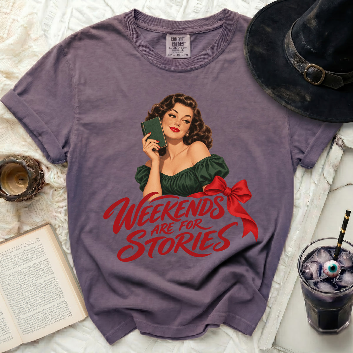 Purple t-shirt with vintage woman holding a book and text "Weekends are for Stories".