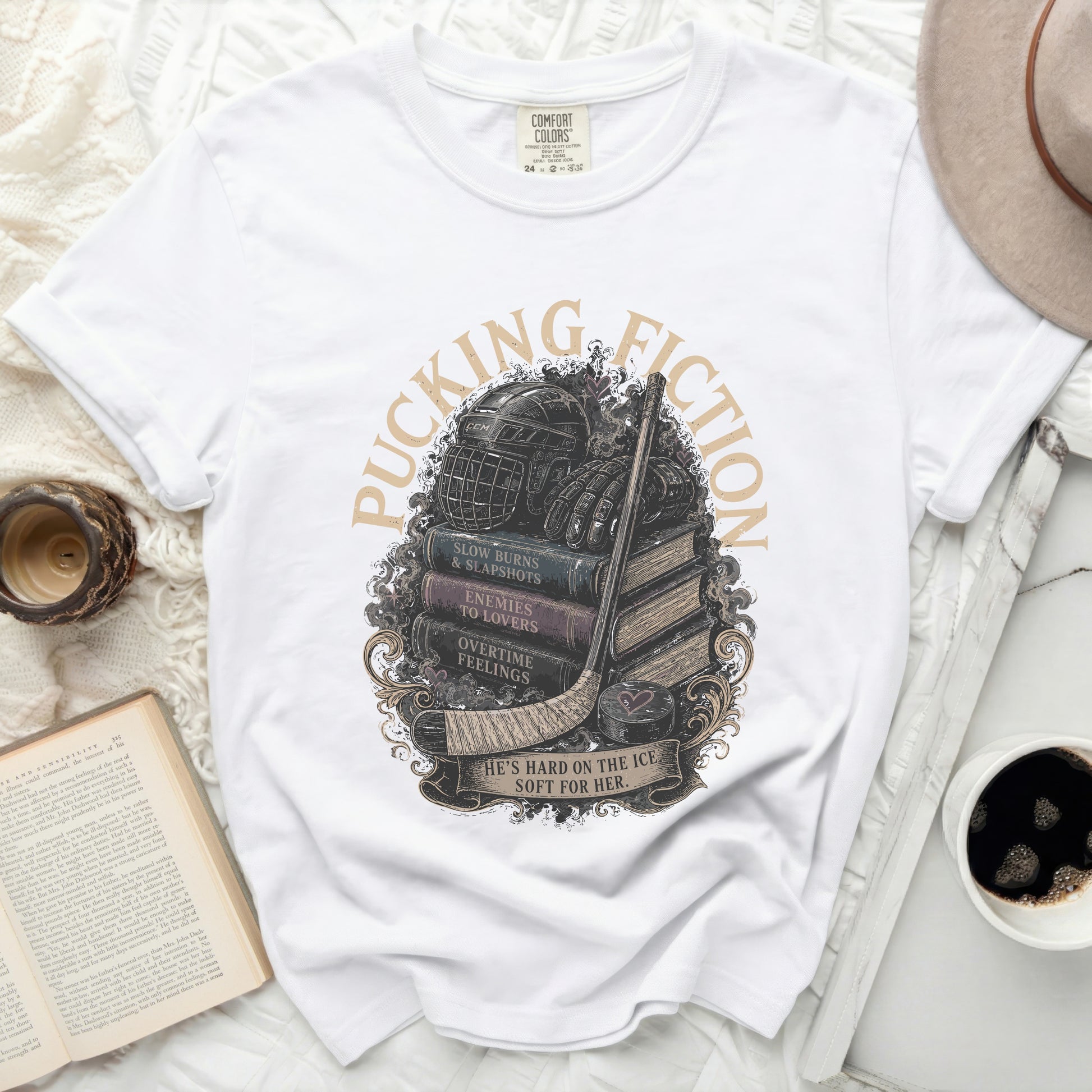 White t-shirt with hockey equipment on stacked books and distressed text.