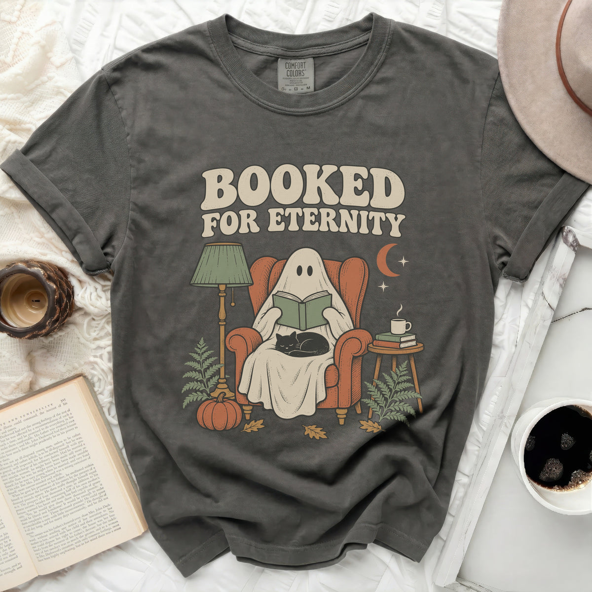 Ghost reading with cat in chair, "Booked For Eternity" text.