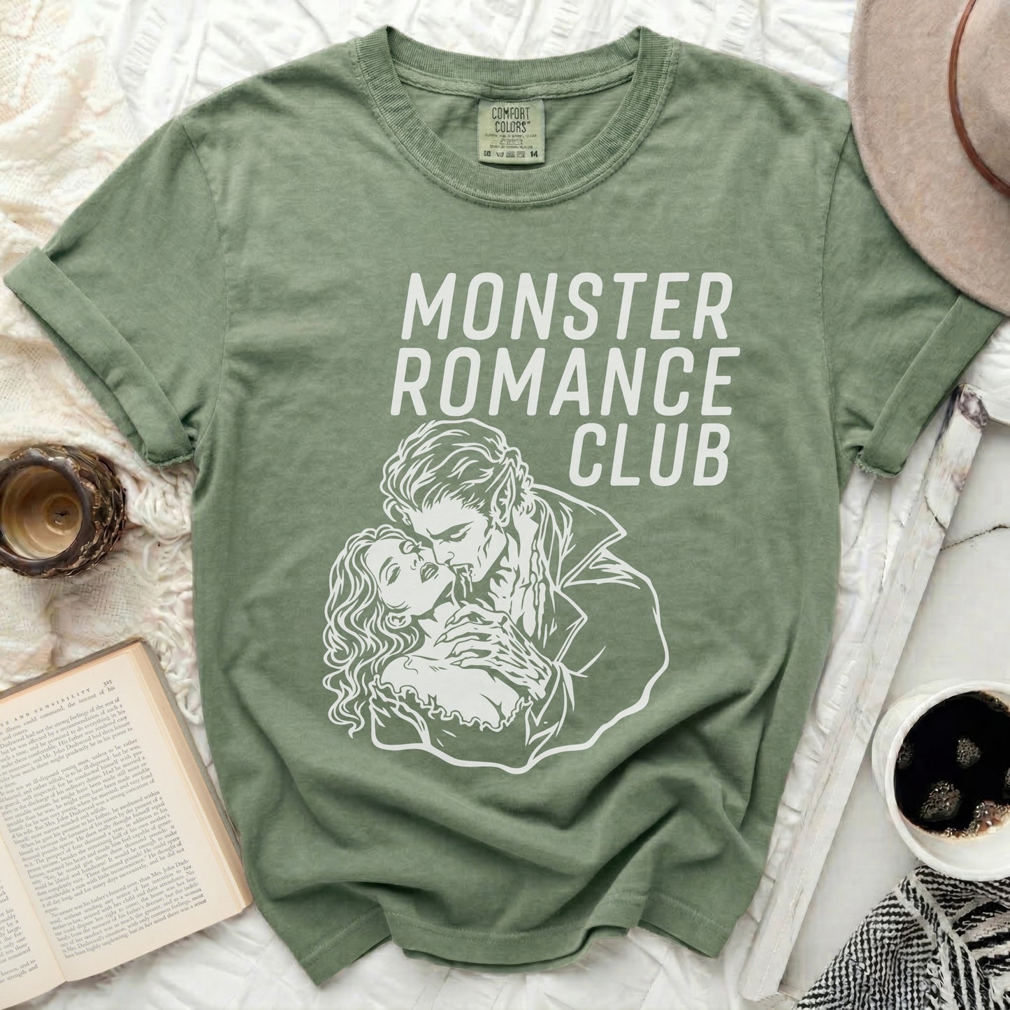 Green t-shirt with "Monster Romance Club" text and a couple illustration.