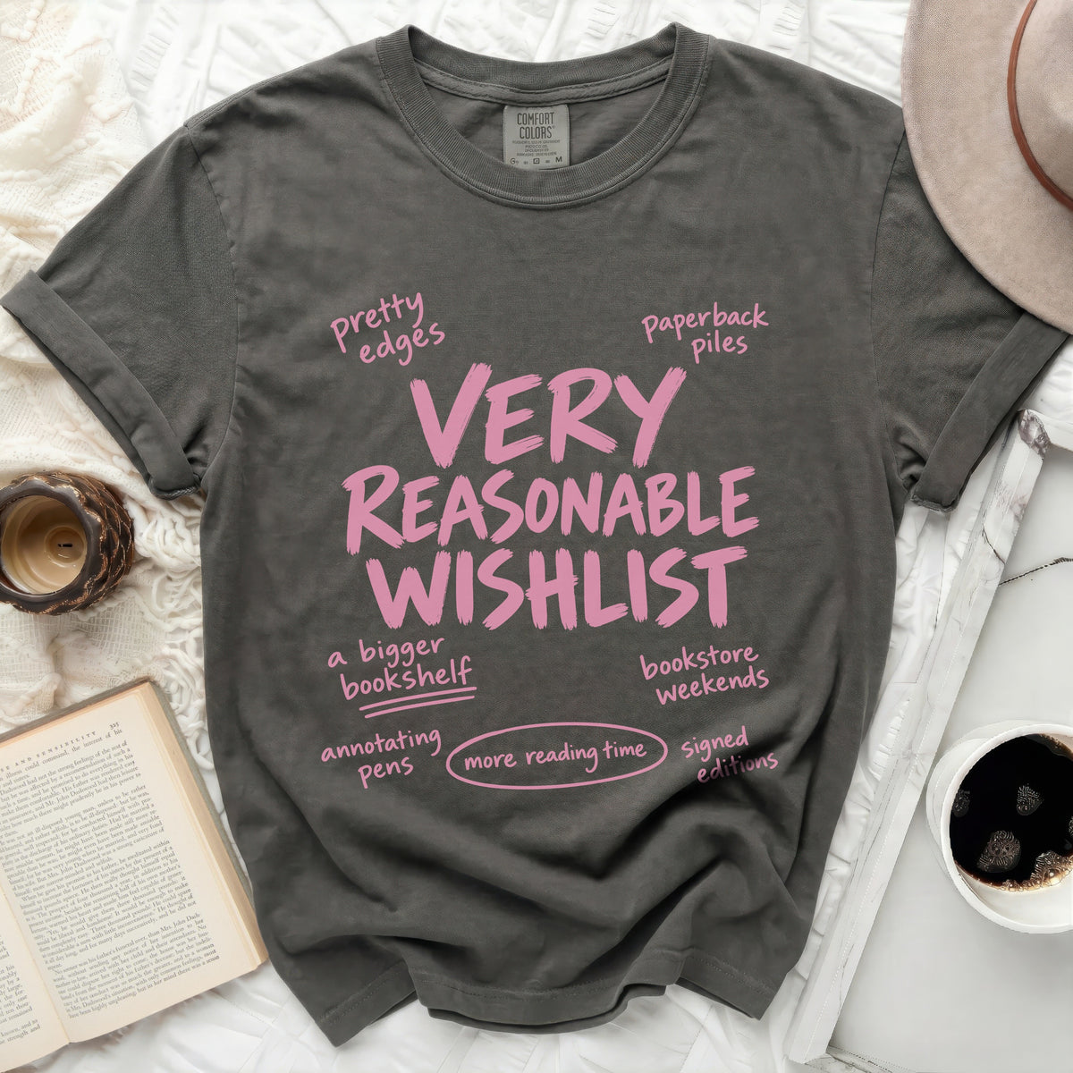 Dark grey t-shirt with pink text listing "VERY REASONABLE WISHLIST".