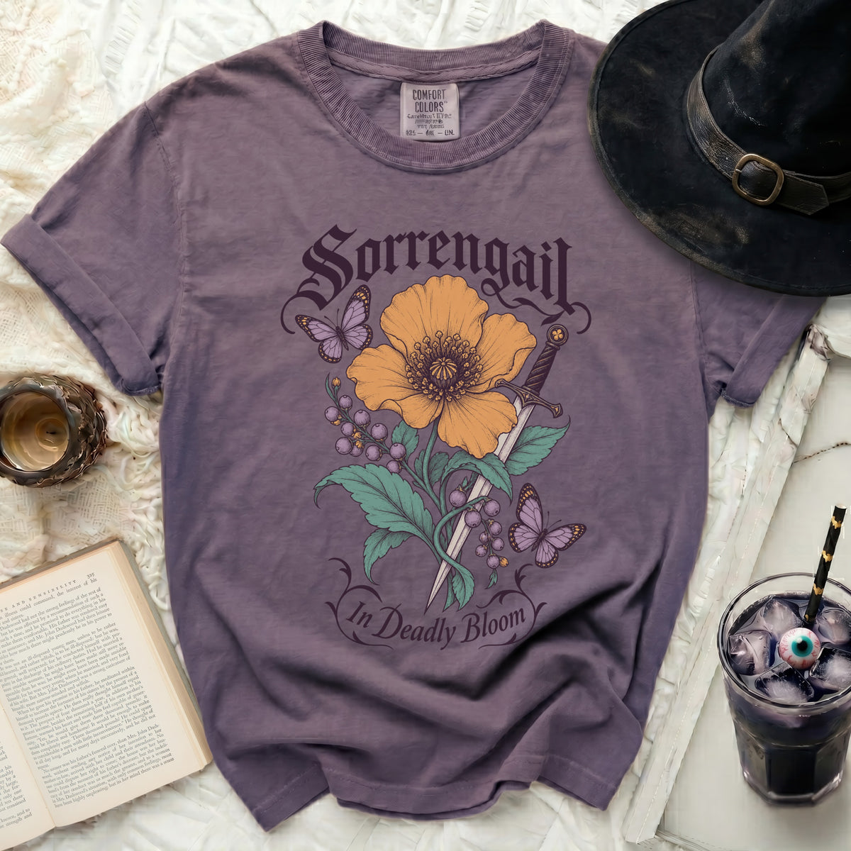 Purple t-shirt with Sorrengail graphic: flower, sword, berries, and butterflies.