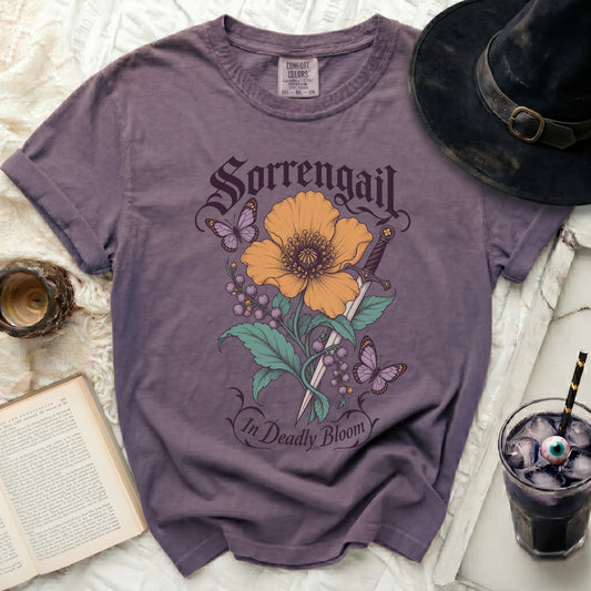 Purple t-shirt with Sorrengail graphic: flower, sword, berries, and butterflies.
