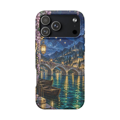 An iPhone case featuring an intricate fantasy river scene with moored boats, an illuminated stone bridge, and mountains under a starry night sky.