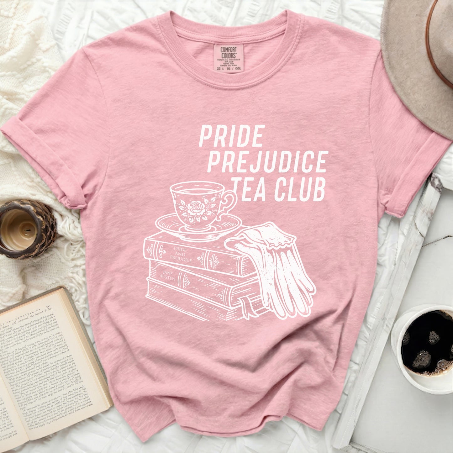 Pink t-shirt with "Pride Prejudice Tea Club" and literary illustrations.