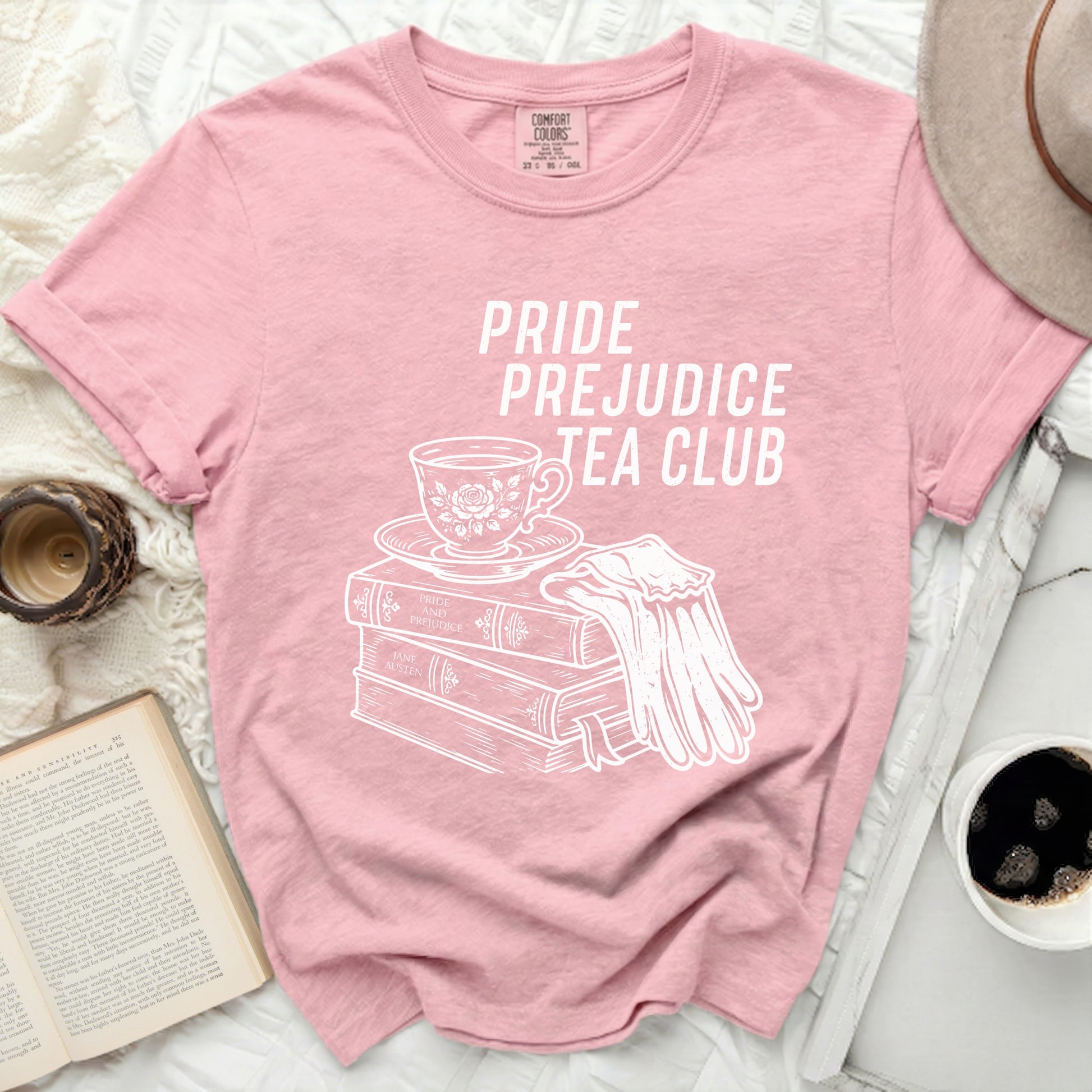 Pink t-shirt with "Pride Prejudice Tea Club" and literary illustrations.
