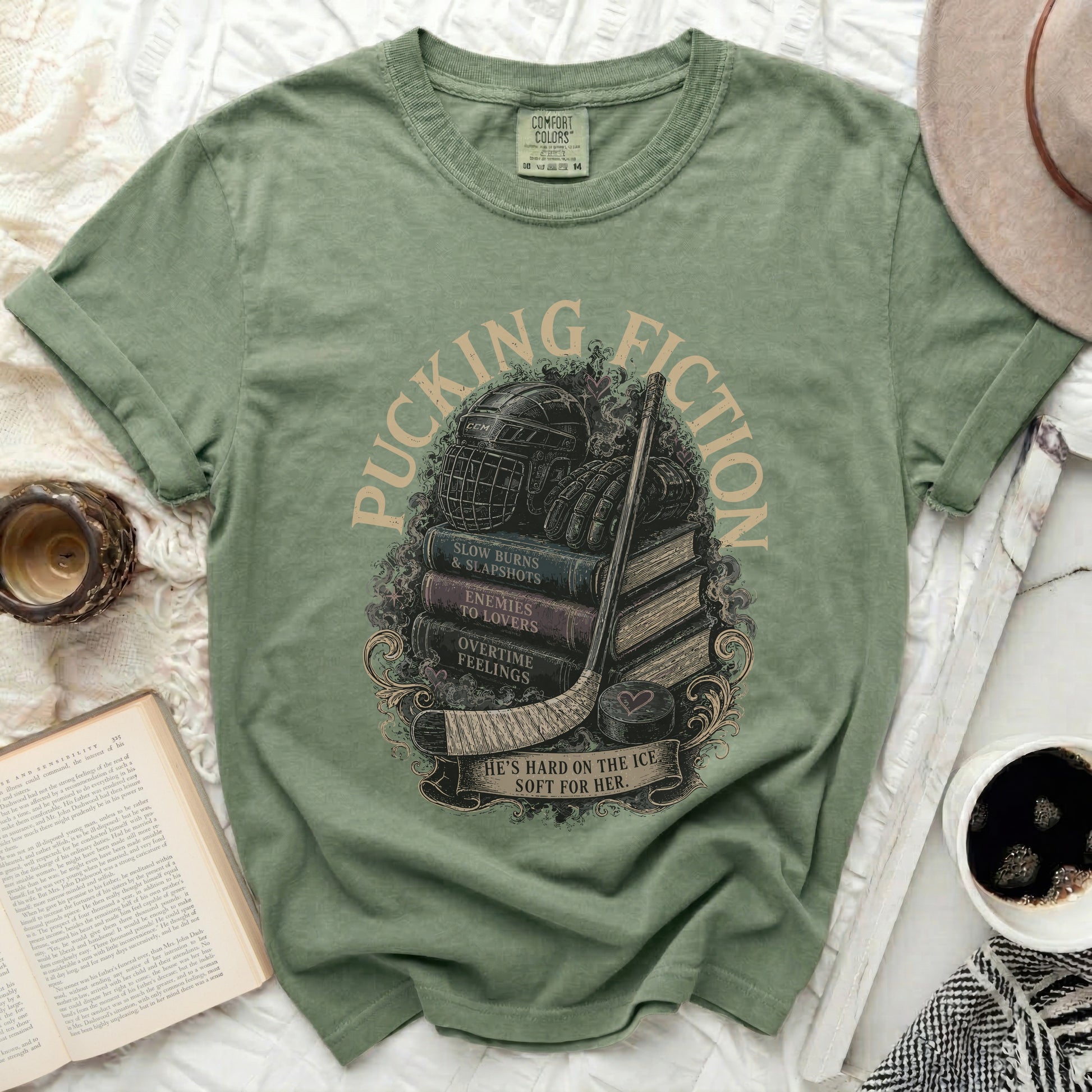 Green t-shirt with "Pucking Fiction" and hockey-themed book stack design.