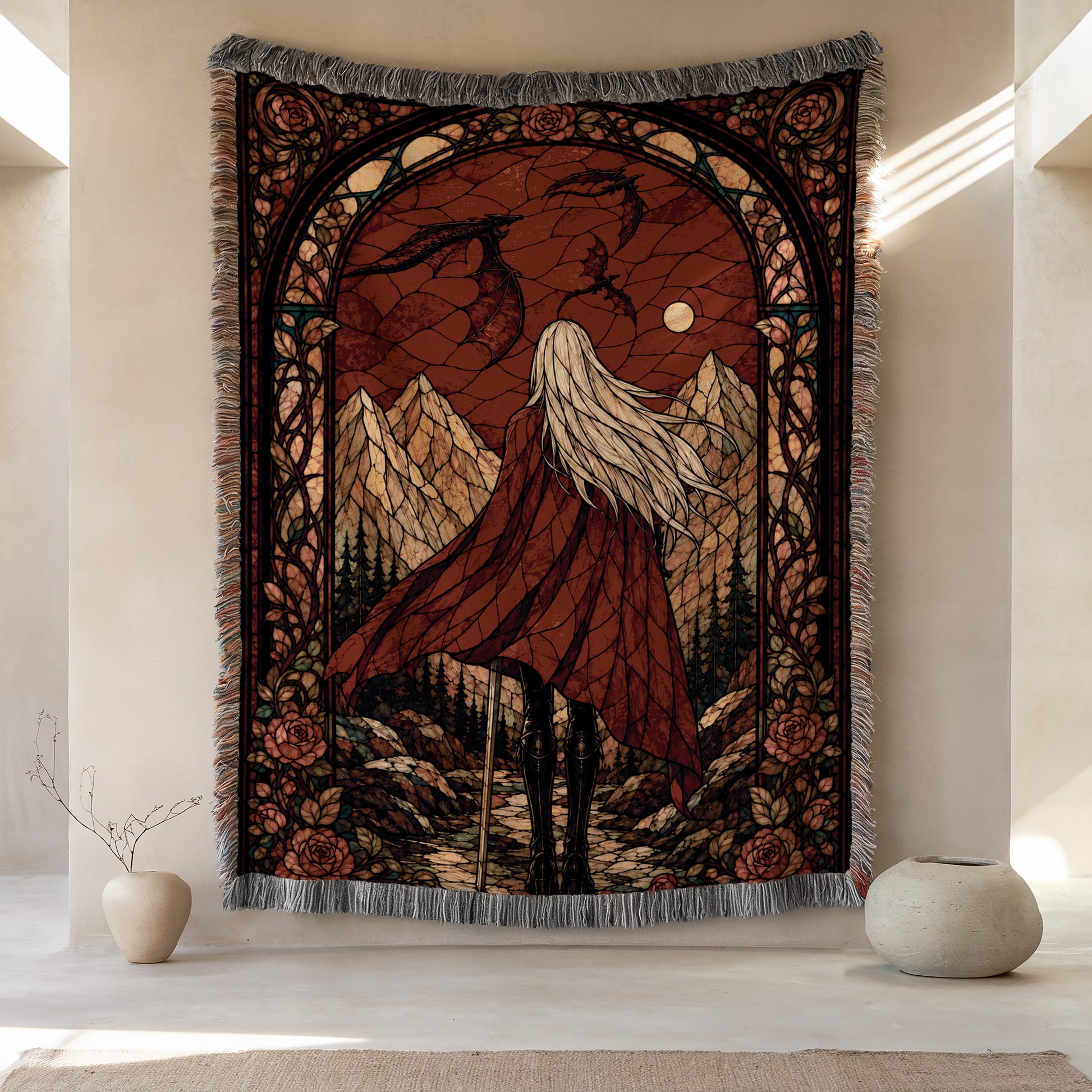 a large tapestry hanging on a wall, depicting a woman with long hair standing in a mountainous landscape. The tapestry is framed by an ornate border and has a red and gold color scheme. There are two small vases placed on either side of the tapestry, and the overall scene is set against a beige wall.