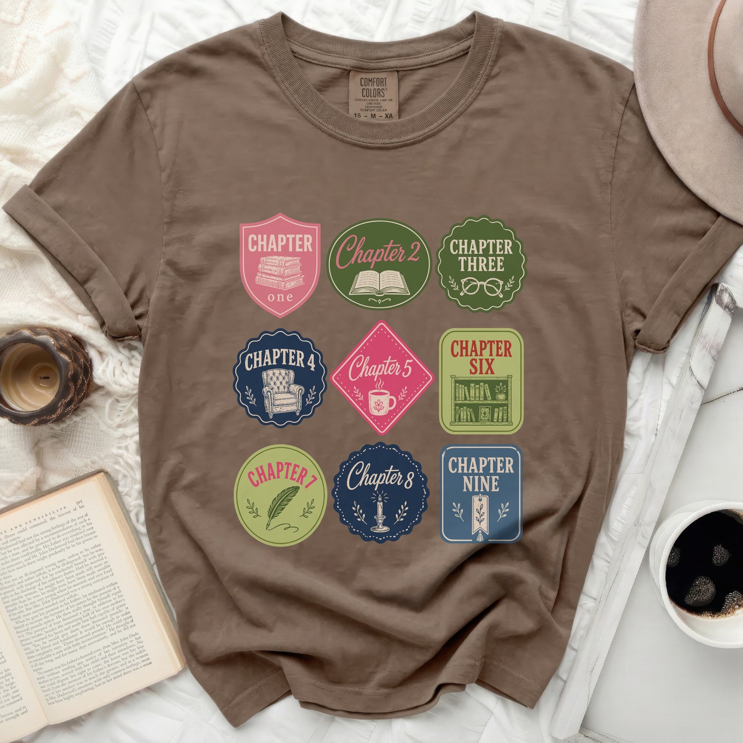Brown t-shirt with "Chapter" themed book and coffee patches.