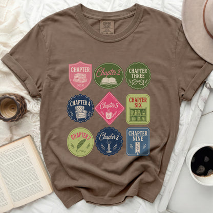 Brown t-shirt with "Chapter" themed book and coffee patches.
