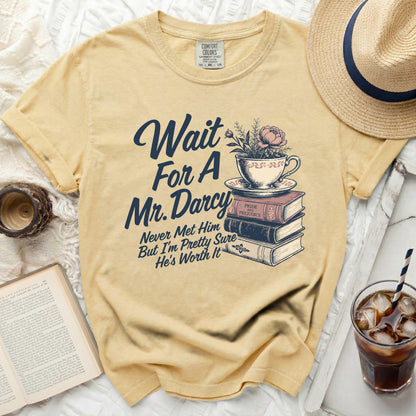 Yellow t-shirt with "Wait For A Mr. Darcy" and graphic on it.