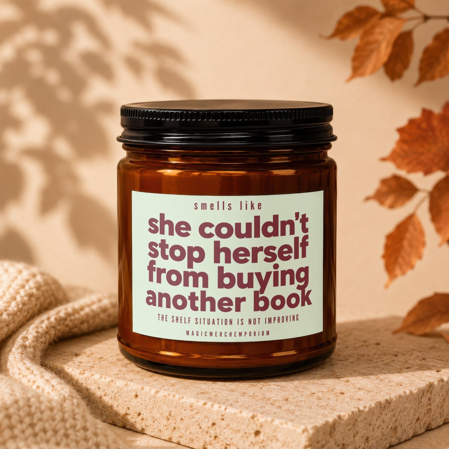 Amber jar candle with text "she couldn't stop herself from buying another book".