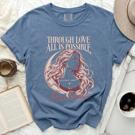 Blue t-shirt with crescent moon and woman graphic, "THROUGH LOVE ALL IS POSSIBLE" and "Bryce Quinlan".