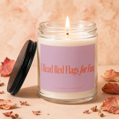 Candle with pink label saying "I Read Red Flags for Fun" and "MAGICMERCHEMPORIUM".