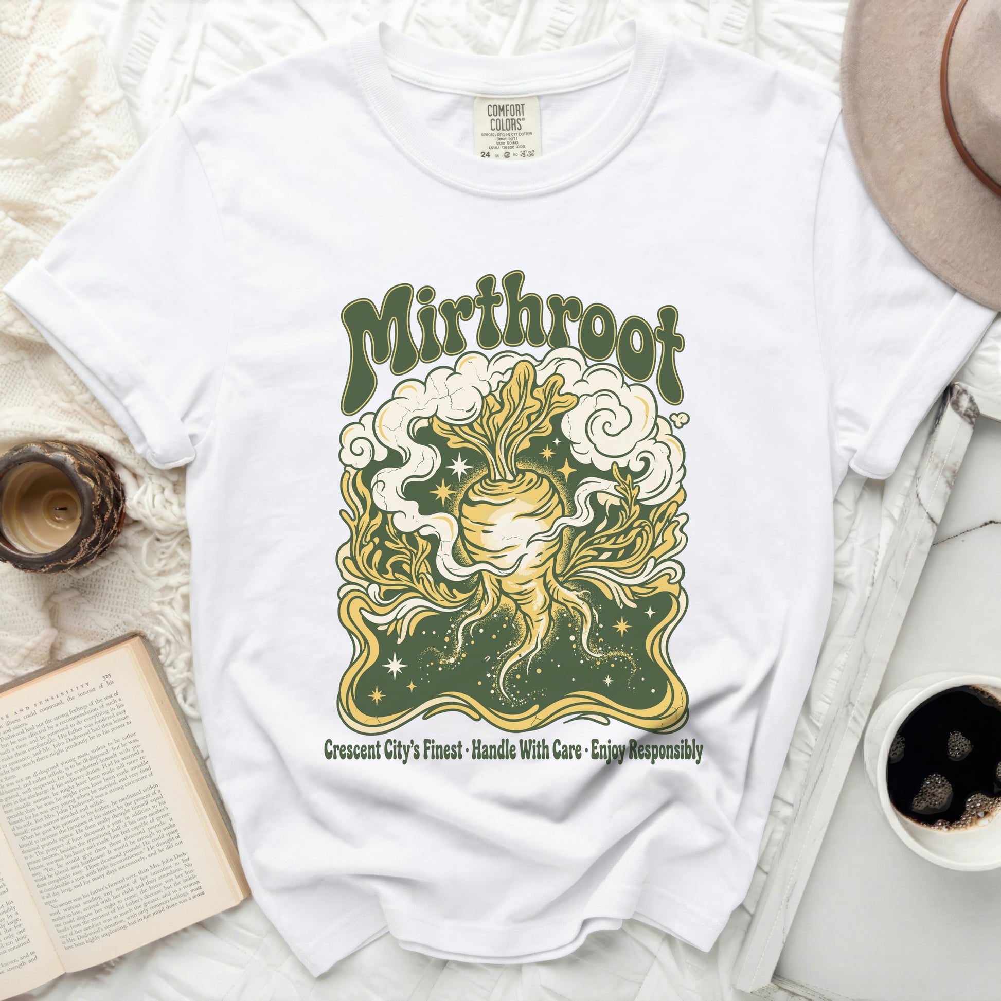 White t-shirt featuring a stylized yellow root vegetable with green leaves and clouds.