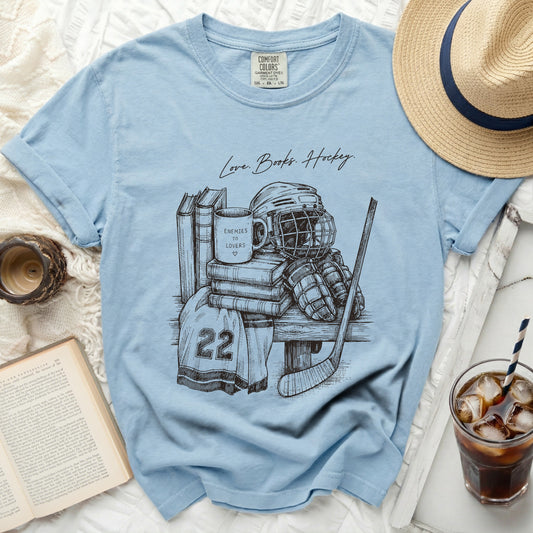 Light blue t-shirt with "Love. Books. Hockey." text and sketch.
