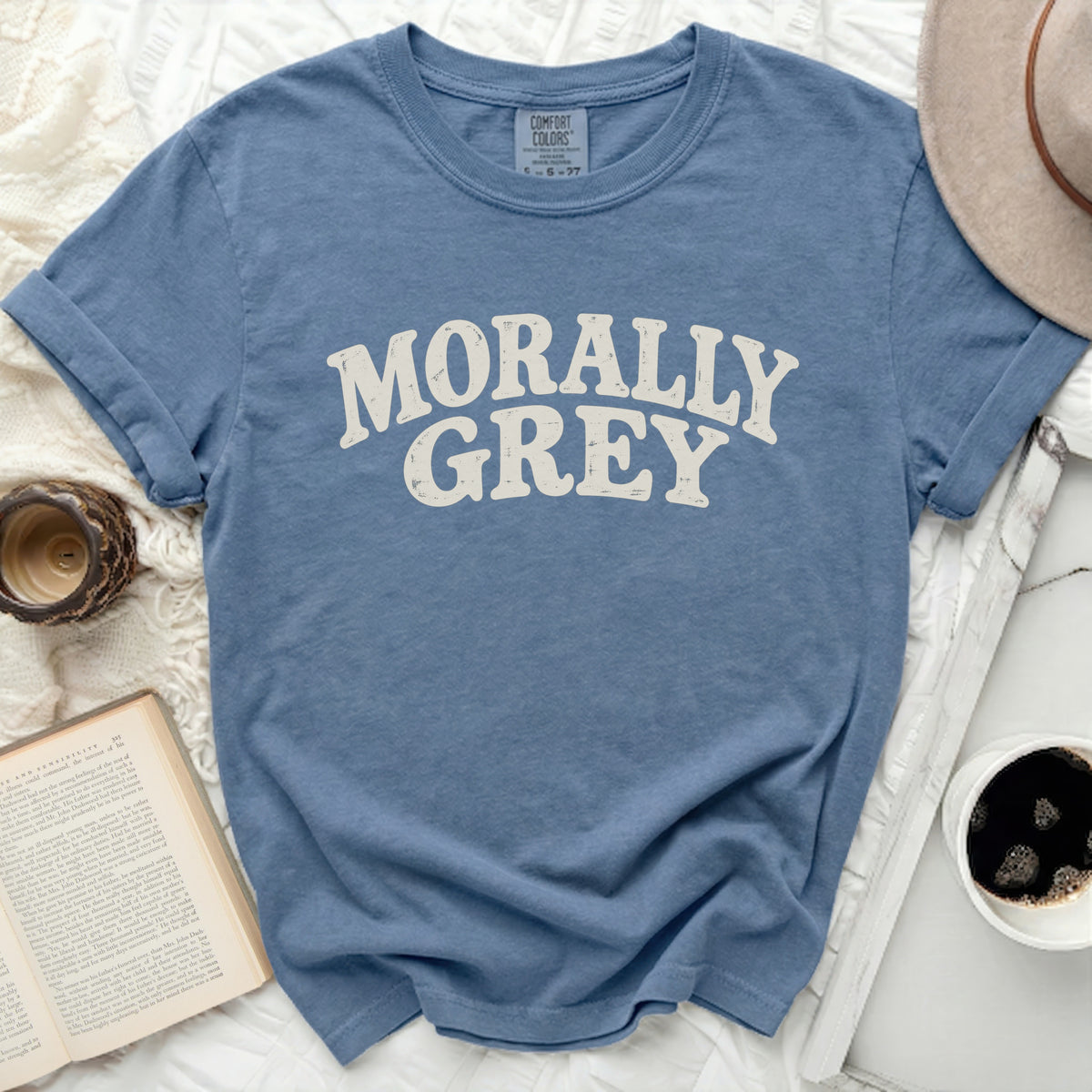 Blue t-shirt with "MORALLY GREY" printed in cream distressed lettering.