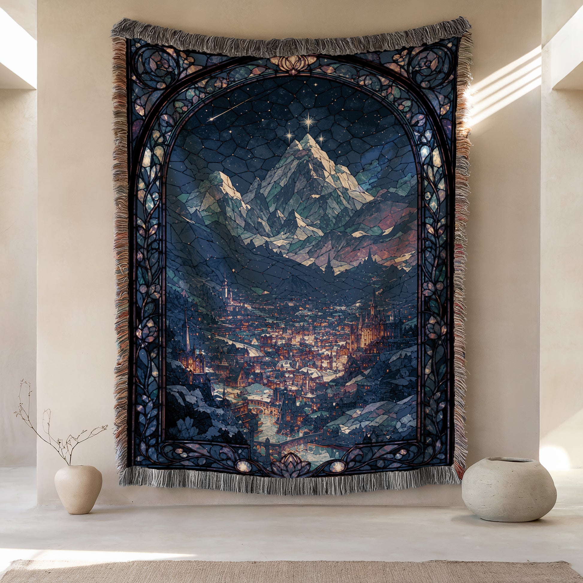 a large tapestry hanging on a wall, depicting a mountainous landscape with a city in the background. The tapestry has a detailed and intricate design, showcasing the craftsmanship and artistry of the creator. The tapestry is framed by a decorative border, adding to its visual appeal. The tapestry is placed on a wall, which is adjacent to a small vase and a potted plant, creating a harmonious and balanced composition in the room.