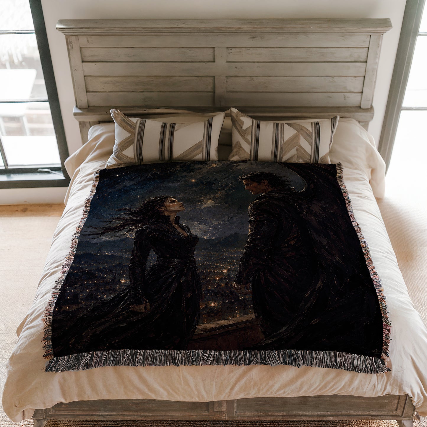 a bed with a large, intricate, and colorful blanket that depicts a scene with two figures, one of which appears to be a woman with long hair and a flowing dress, and the other a man with a cape. The blanket is spread over the bed, covering the entire surface.