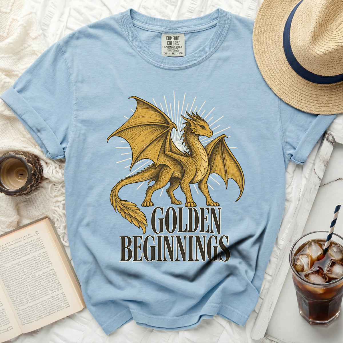 Light blue t-shirt with golden dragon graphic and text "GOLDEN BEGINNINGS".