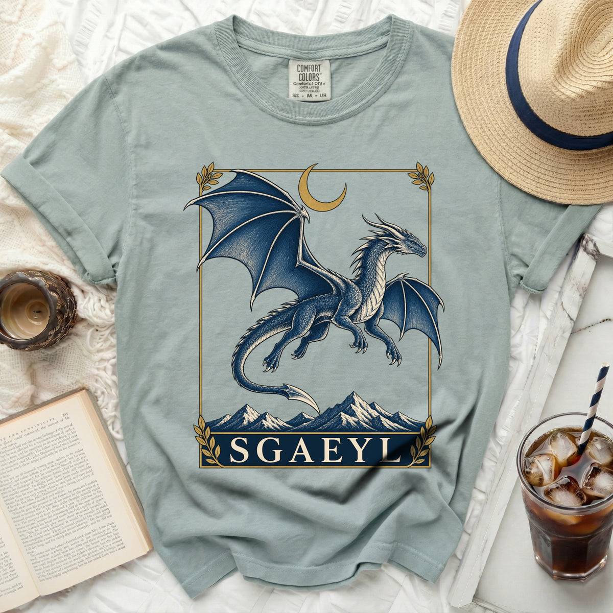 Light blue t-shirt with a blue dragon graphic and text "SGAEYL".