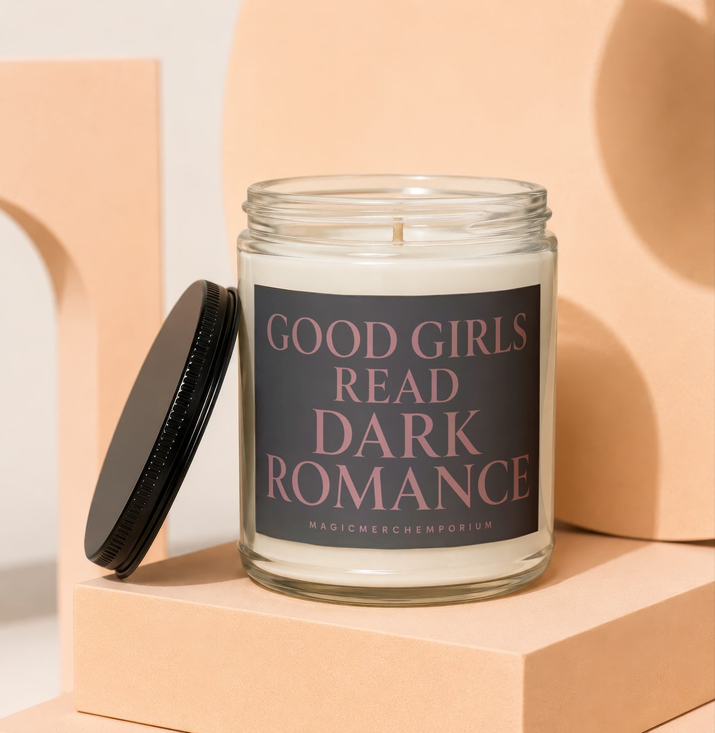 Glass jar candle with lid removed, text reads "Good Girls Read Dark Romance".