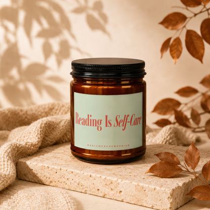 Amber candle with "Reading Is Self-Care" label and "MAGICMERCHEMPORIUM" text.