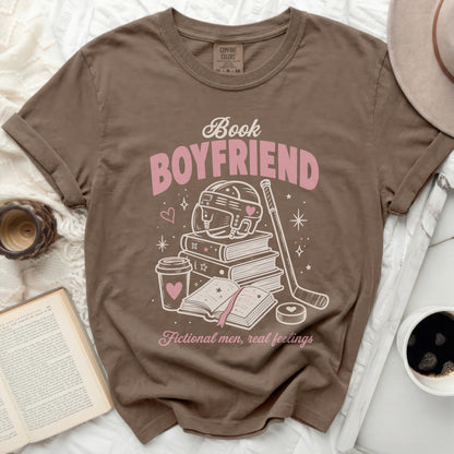 Brown t-shirt with "Book Boyfriend" text, books, hockey gear, and hearts.