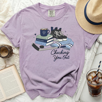 Purple comfort colors t-shirt with hockey skates, books, and mug graphic.