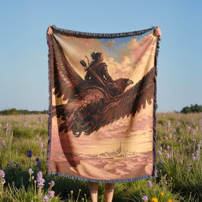 A person is holding a large tapestry or blanket with a painting of a person riding a winged creature, possibly a dragon or eagle, against a backdrop of a cityscape.