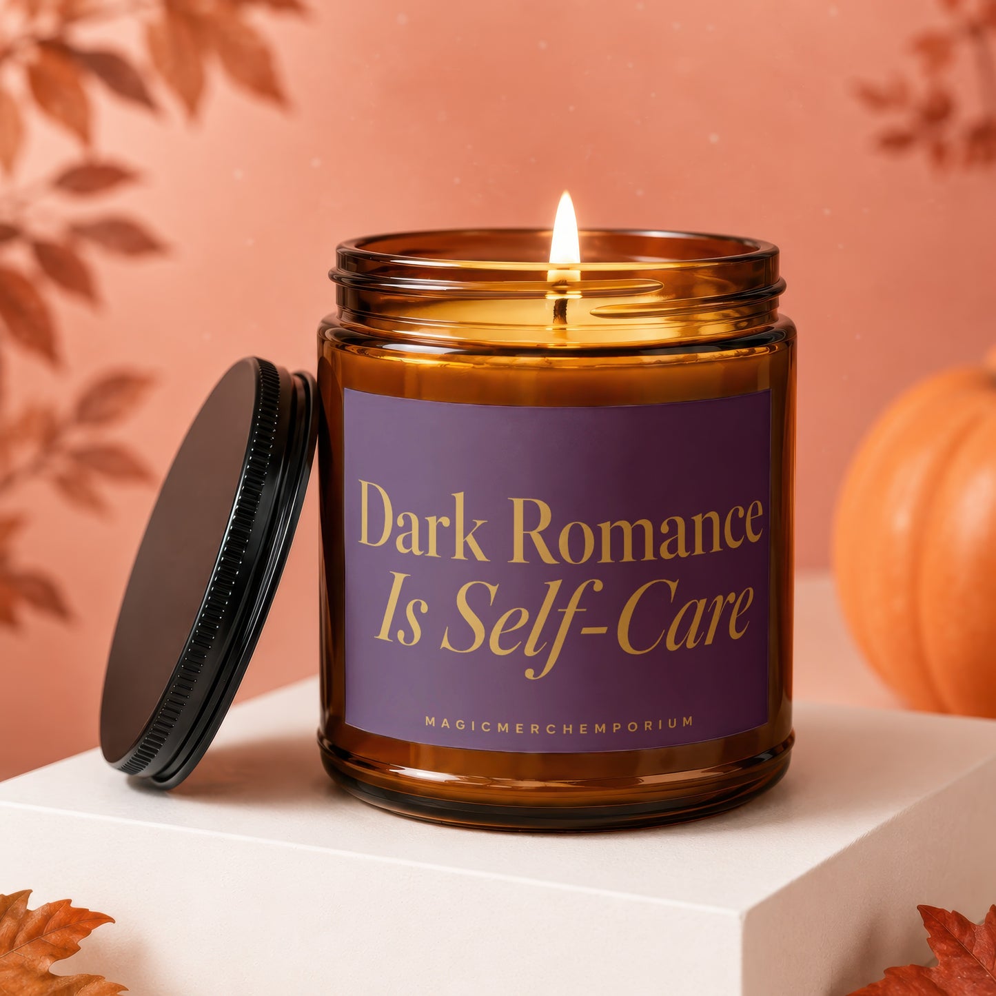 Amber candle with lit wick, purple label reads "Dark Romance Is Self-Care".