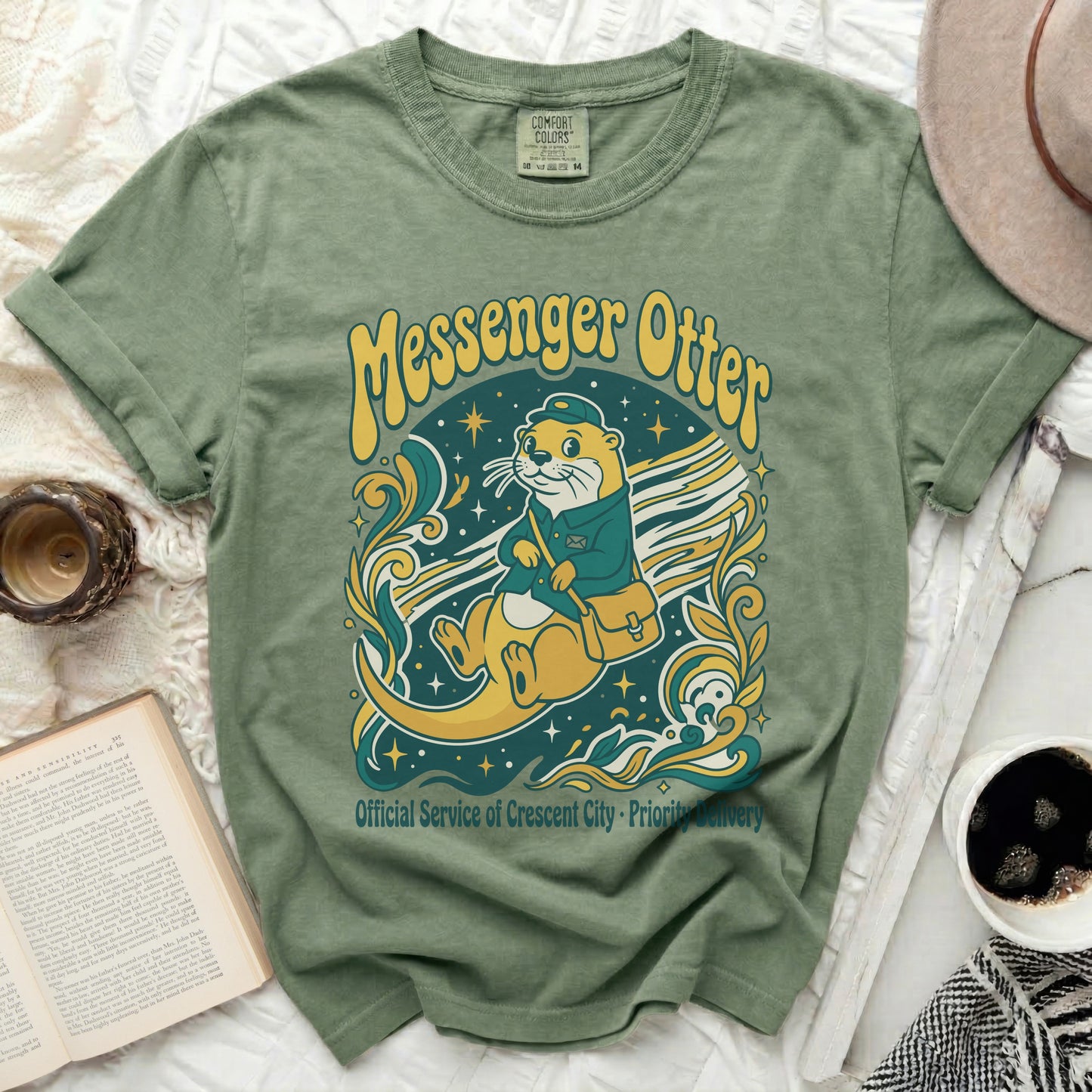 Green t-shirt featuring a messenger otter graphic with "Messenger Otter" text.