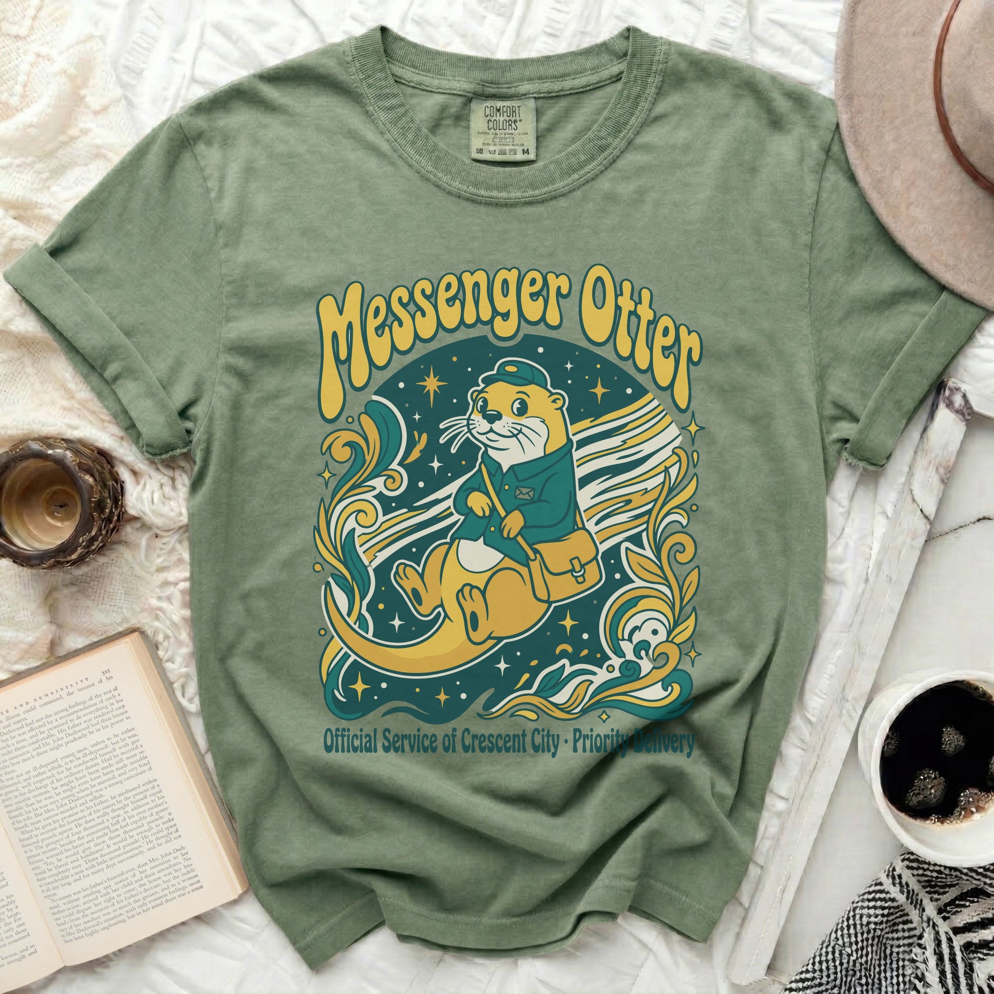 Green t-shirt featuring a messenger otter graphic with "Messenger Otter" text.