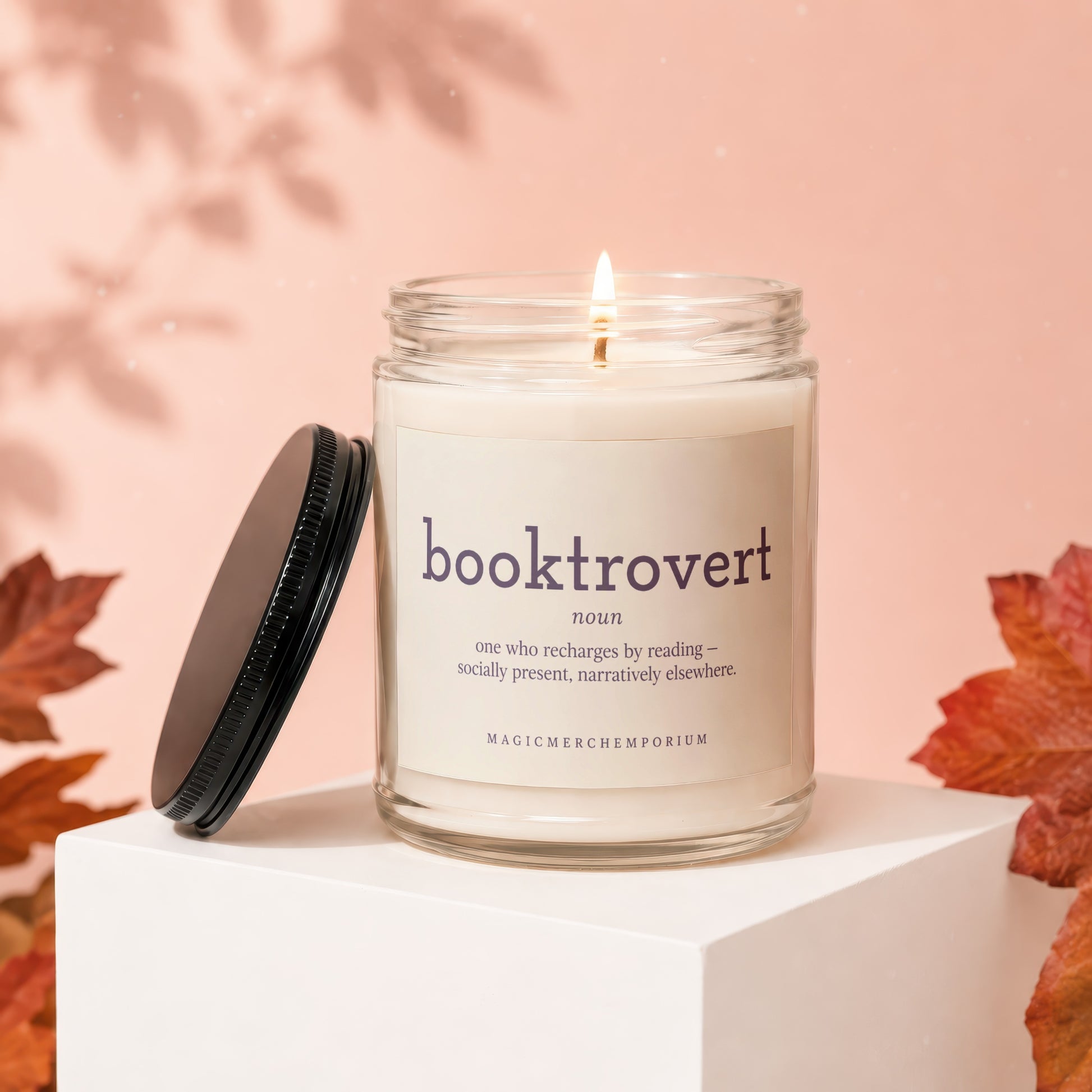 Booktrovert candle with definition: "one who recharges by reading - socially present, narratively elsewhere."
