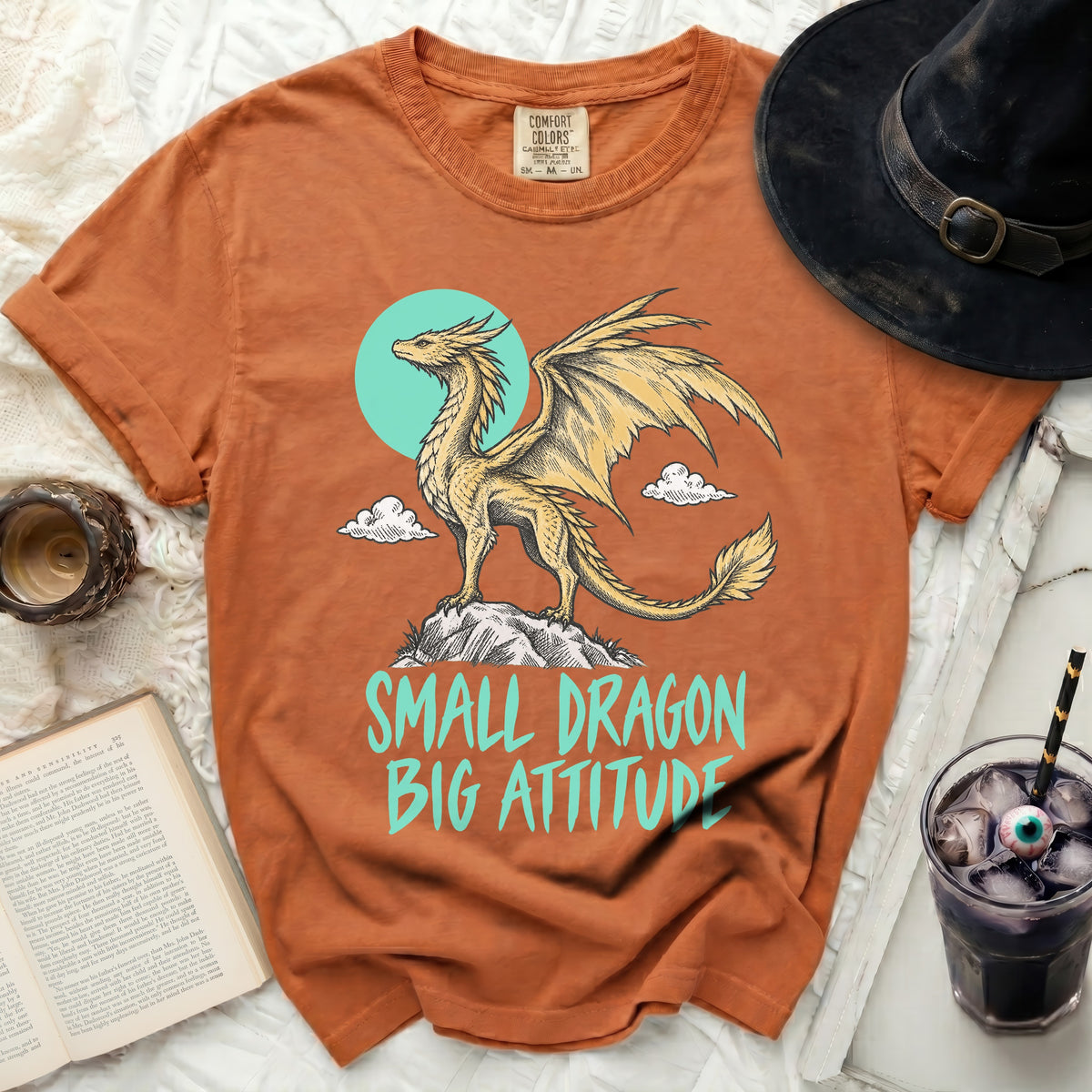 Orange t-shirt with yellow dragon graphic and "SMALL DRAGON BIG ATTITUDE" text.