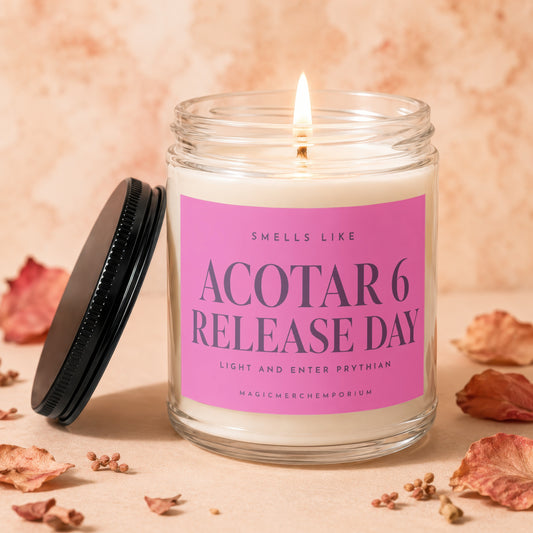 Glass candle with pink label that reads "ACOTAR 6 RELEASE DAY".