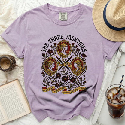 Purple t-shirt with "The Three Valkyries" artwork featuring Emerie, Nesta, and Gwyn.