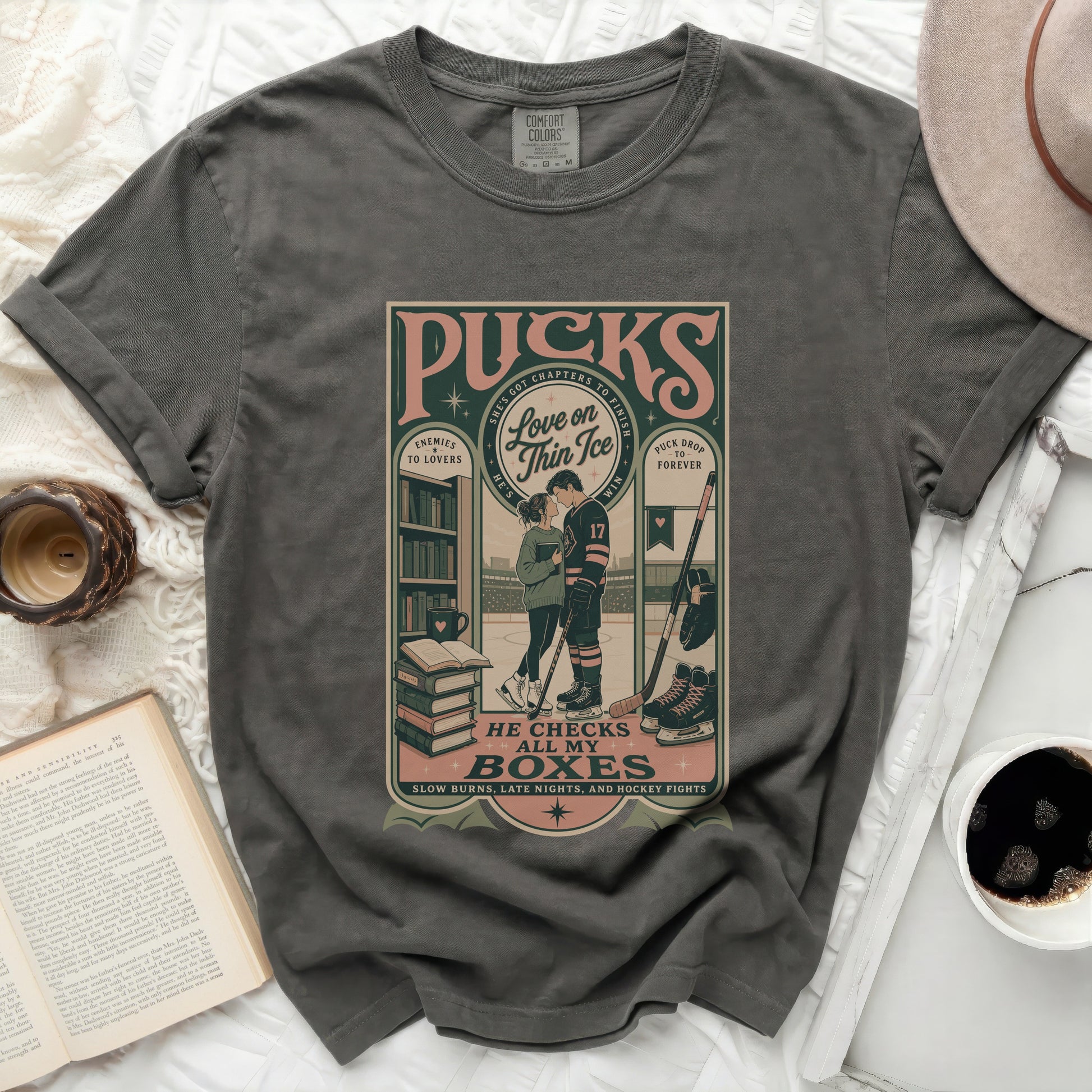 T-shirt with "Pucks: Enemies to Lovers" and hockey imagery.