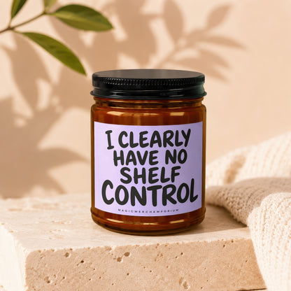 Amber jar candle with black lid and lavender label, "I CLEARLY HAVE NO SHELF CONTROL".