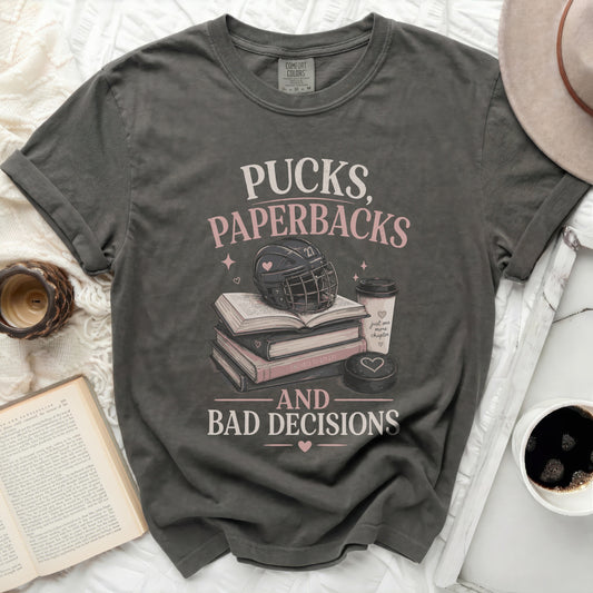 T-shirt with "Pucks, Paperbacks, and Bad Decisions" text, hockey puck, and books.